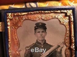 Authentic Civil War tin type of a Union Soldier holding three weapons